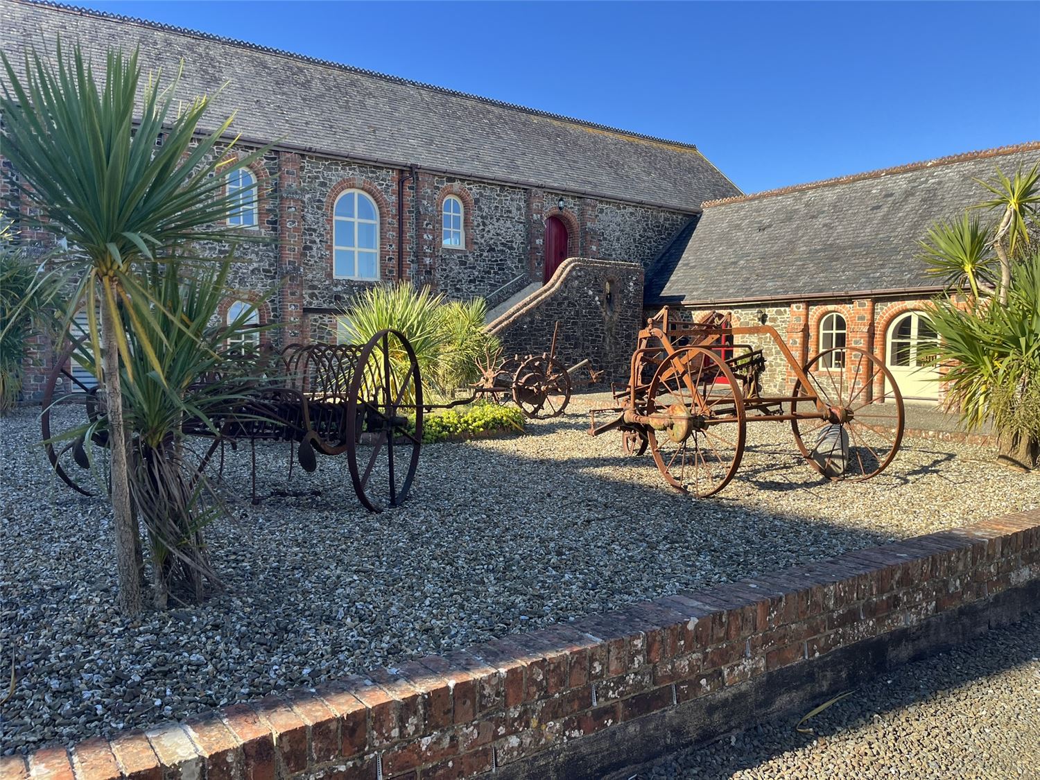 The court yard at Highford Farm with machinery that was used in the Victorian Era when the farm was a working one