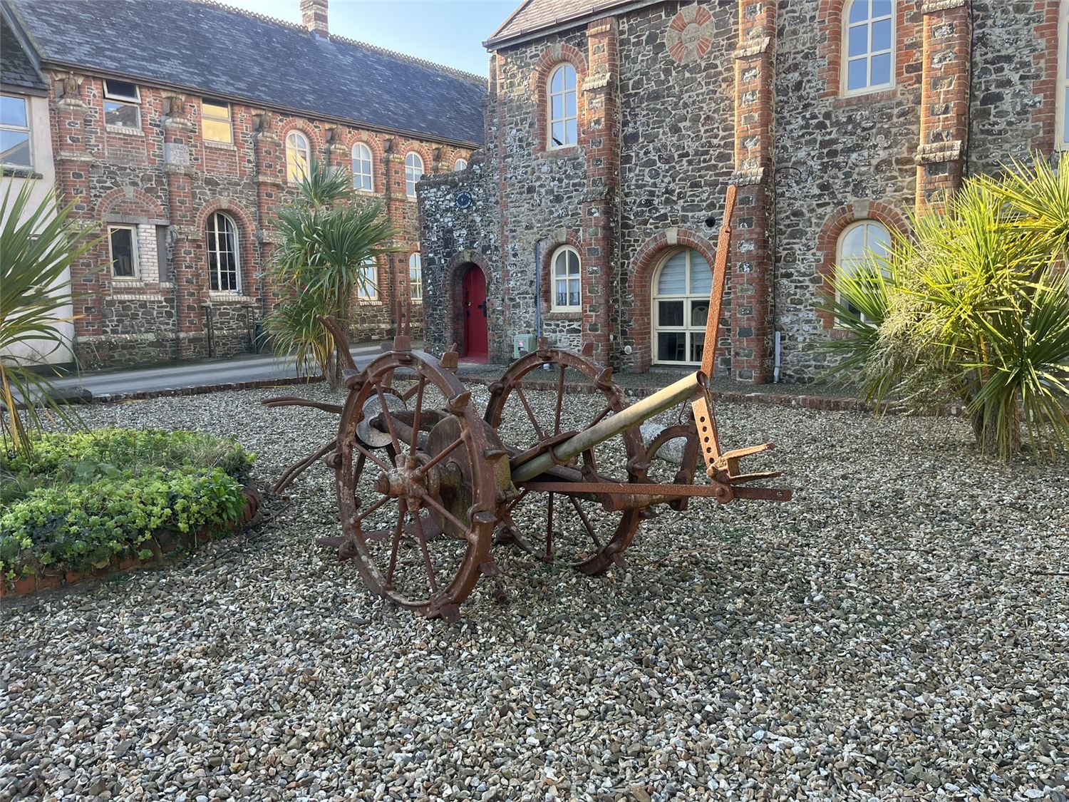 The court yard at Highford Farm with machinery that was used in the Victorian Era when the farm was a working one