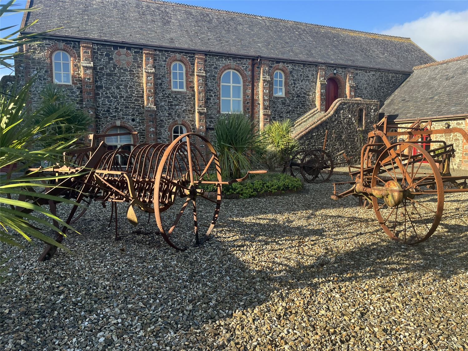 The court yard at Highford Farm with machinery that was used in the Victorian Era when the farm was a working one