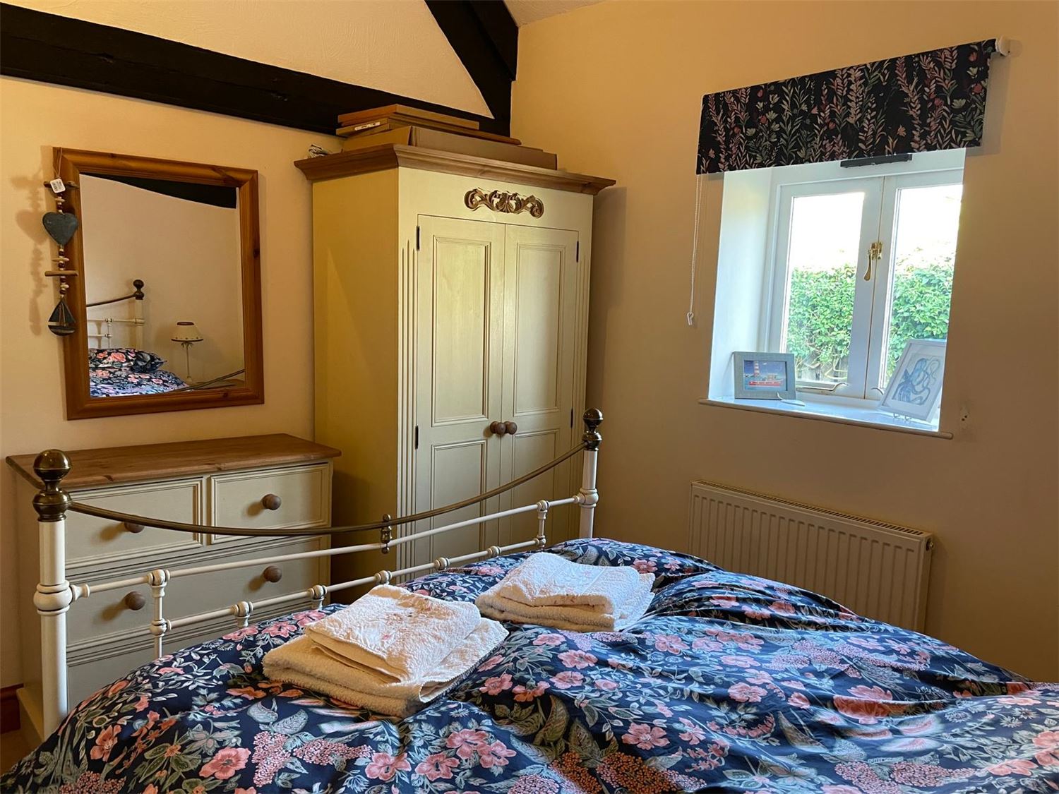 The main bedroom with double bed, chest of drawers and wardrobe